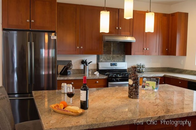 2100 Symonds Dr, Frazier Park, CA 93222 - kitchen featuring under cabinet range hood, light stone counters, appliances with stainless steel finishes, and hanging light fixtures