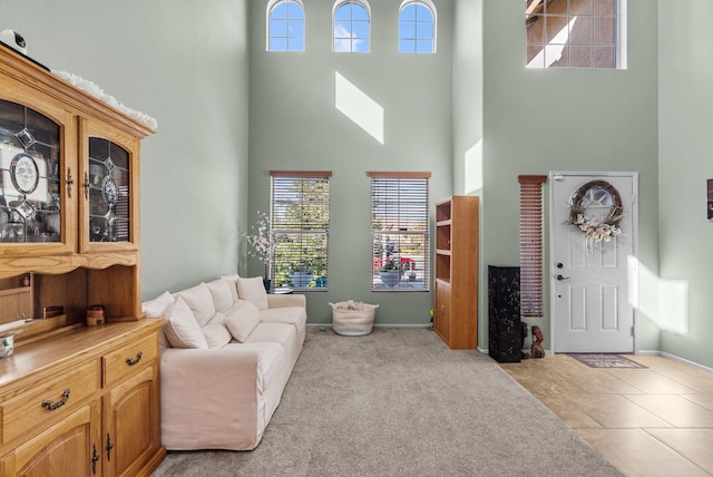 carpeted living room with a high ceiling