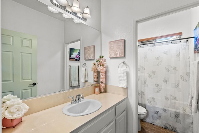 full bathroom with vanity, shower / bath combination with curtain, and toilet