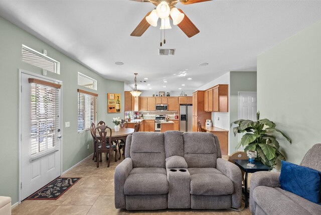 living room with ceiling fan and light tile patterned floors