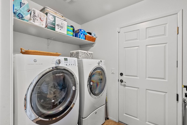 laundry area with washing machine and clothes dryer