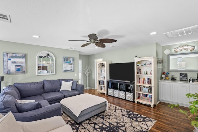 living room with ceiling fan and dark wood-type flooring