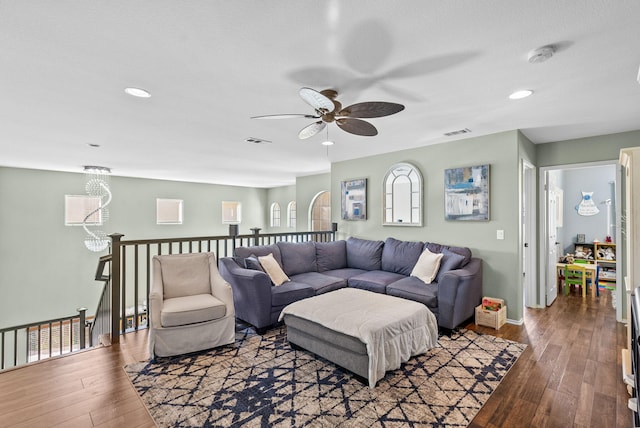 living room featuring wood-type flooring and ceiling fan