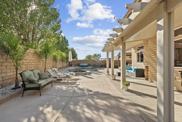 view of patio / terrace featuring outdoor lounge area and an in ground hot tub