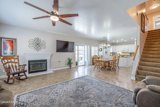 1776 Blackberry Ct, Palmdale, CA 93551 - living area featuring stairs, a ceiling fan, a glass covered fireplace, light tile patterned flooring, and a chandelier
