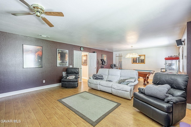 1776 Blackberry Ct, Palmdale, CA 93551 - living room with pool table, light wood-style floors, ceiling fan, a chandelier, and a textured wall