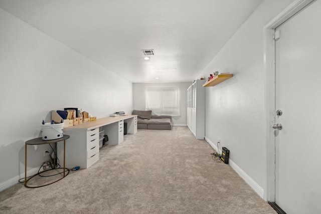 interior space with visible vents, light carpet, and baseboards
