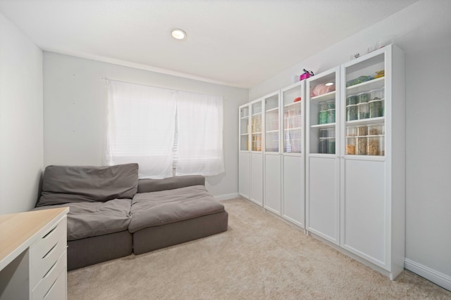 living room with baseboards and light carpet