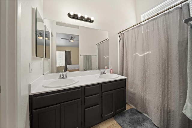 ensuite bathroom featuring double vanity, ceiling fan, ensuite bathroom, and a sink