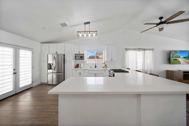 kitchen featuring visible vents, light countertops, appliances with stainless steel finishes, and lofted ceiling