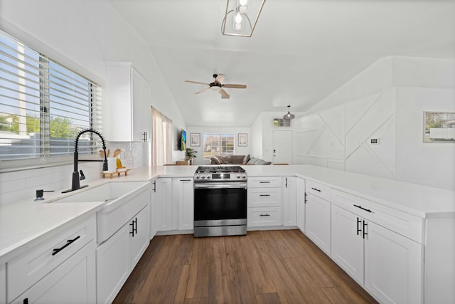 kitchen featuring tasteful backsplash, ceiling fan, vaulted ceiling, gas stove, and dark wood-type flooring