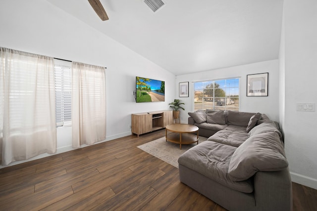 living area with dark wood-style flooring, visible vents, vaulted ceiling, and baseboards