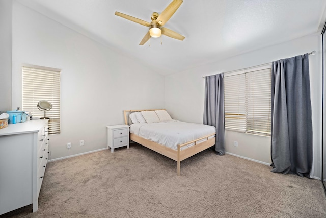 bedroom with baseboards, a ceiling fan, lofted ceiling, and light colored carpet