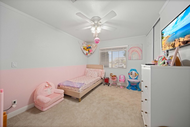 carpeted bedroom featuring ornamental molding and ceiling fan