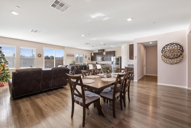 dining area with dark hardwood / wood-style flooring