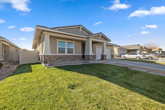 craftsman-style house featuring a front lawn and a garage