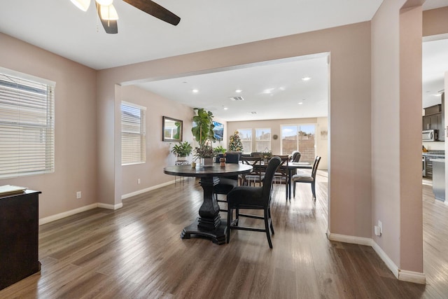 dining area featuring ceiling fan and wood-type flooring