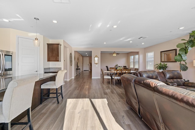 living room featuring ceiling fan and light wood-type flooring