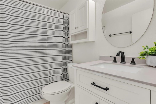 bathroom featuring vanity, a shower with shower curtain, and toilet