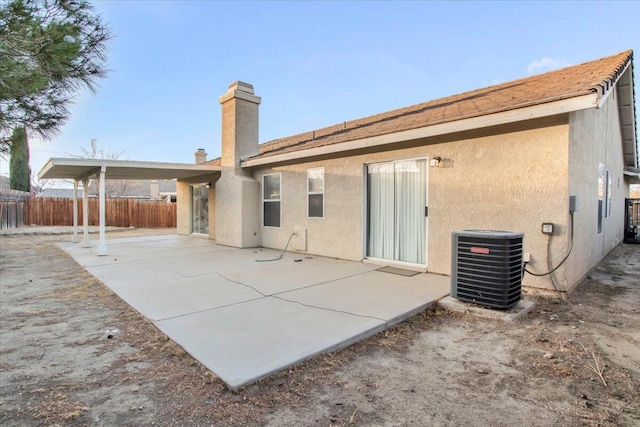 back of house with cooling unit and a patio