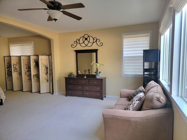 interior space featuring ceiling fan and light carpet