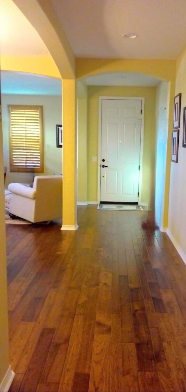 corridor with dark hardwood / wood-style floors