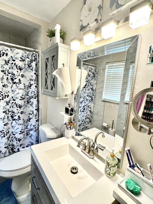 43744 Beech Ave, Lancaster, CA 93534 - full bath featuring vanity, toilet, a textured wall, and a shower with shower curtain
