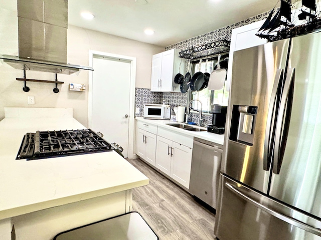 43744 Beech Ave, Lancaster, CA 93534 - kitchen with appliances with stainless steel finishes, a sink, light wood-style floors, extractor fan, and recessed lighting