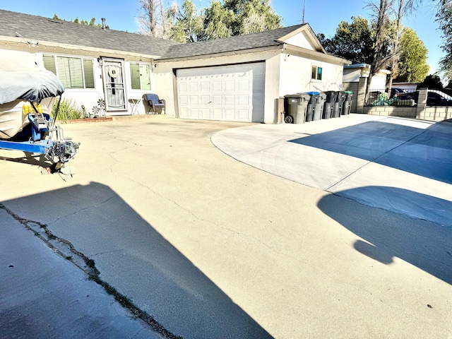 43744 Beech Ave, Lancaster, CA 93534 - view of front of home with stucco siding, concrete driveway, a garage, and a shingled roof