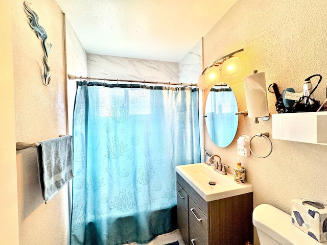 43744 Beech Ave, Lancaster, CA 93534 - bathroom with vanity, a textured wall, shower / bath combo, and toilet