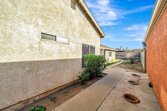 2820 S S Ave, Palmdale, CA 93550 - view of property exterior with fence, stucco siding, and a patio area