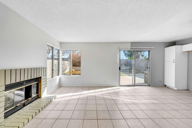2820 S S Ave, Palmdale, CA 93550 - unfurnished living room with a brick fireplace, light tile patterned floors, and a wealth of natural light