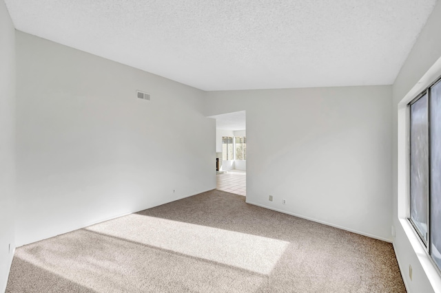 2820 S S Ave, Palmdale, CA 93550 - carpeted empty room featuring a textured ceiling, vaulted ceiling, and visible vents