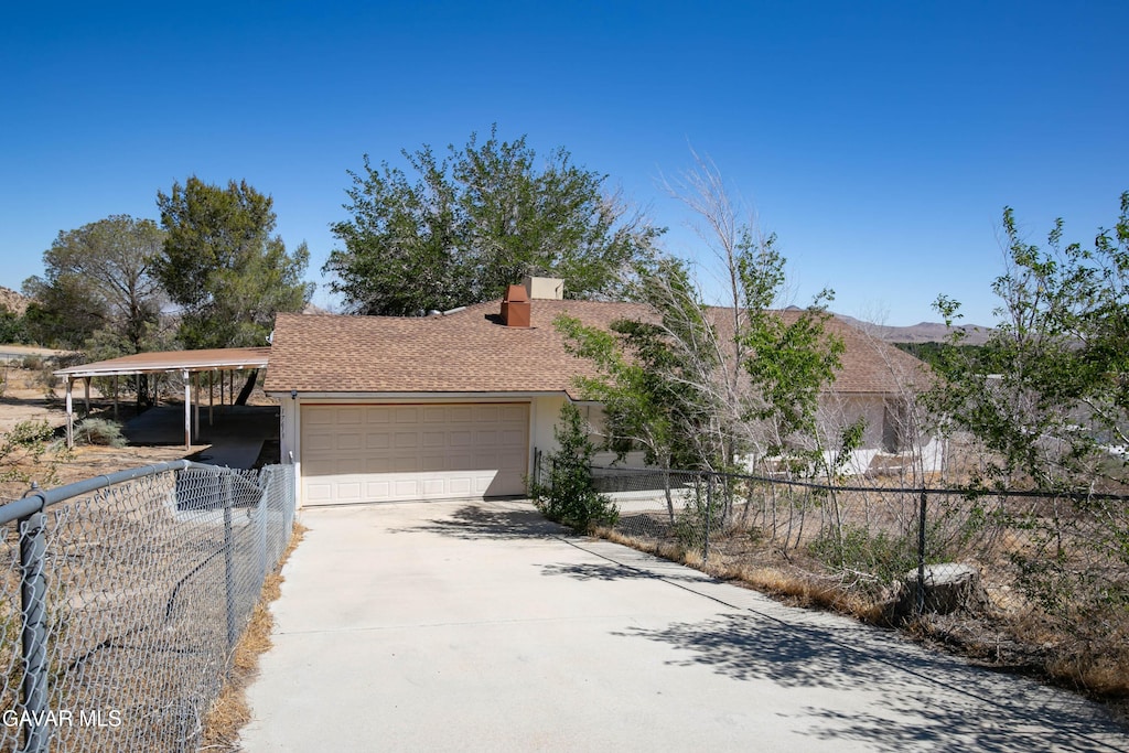 17613 Lakespring Ave, Lake Los Angeles, CA 93591 - view of front of house with driveway, an attached garage, a chimney, and stucco siding