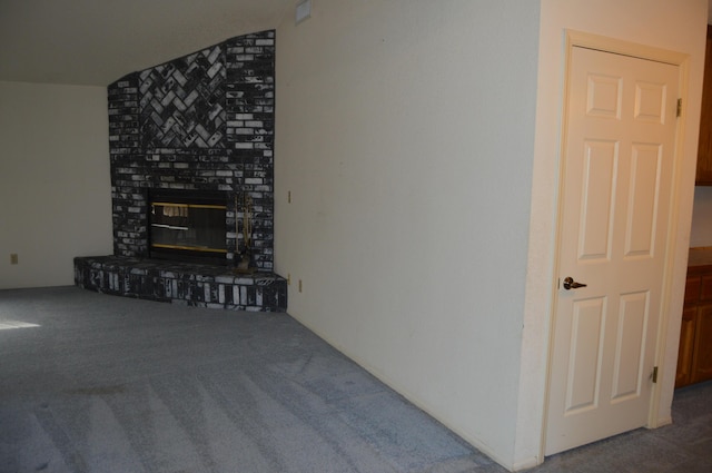 unfurnished living room with carpet and a brick fireplace
