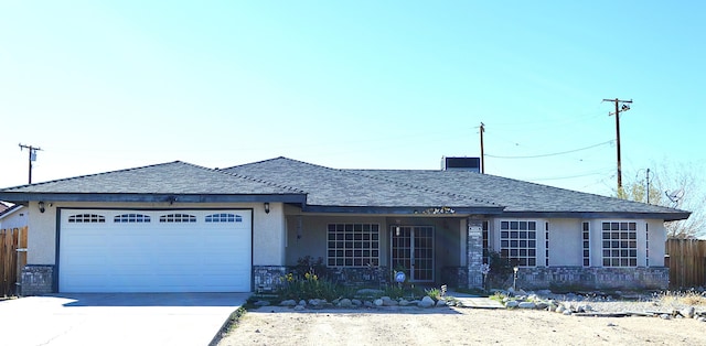single story home featuring fence, driveway, stucco siding, and an attached garage