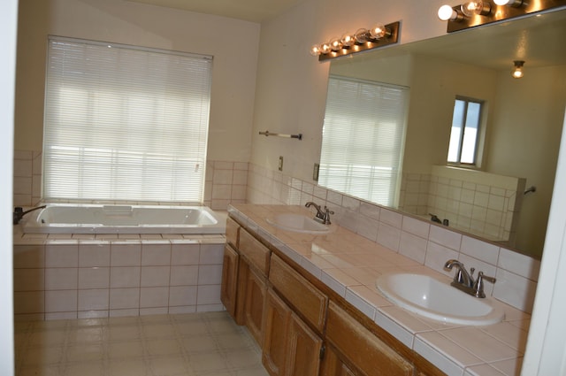 bathroom featuring double vanity, a sink, tile patterned floors, and a bath