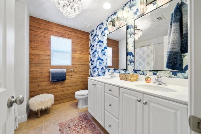 bathroom with visible vents, a sink, an inviting chandelier, and tile patterned floors