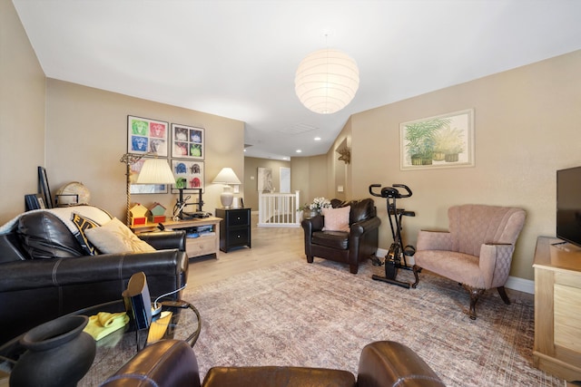 living room with light wood-type flooring and baseboards