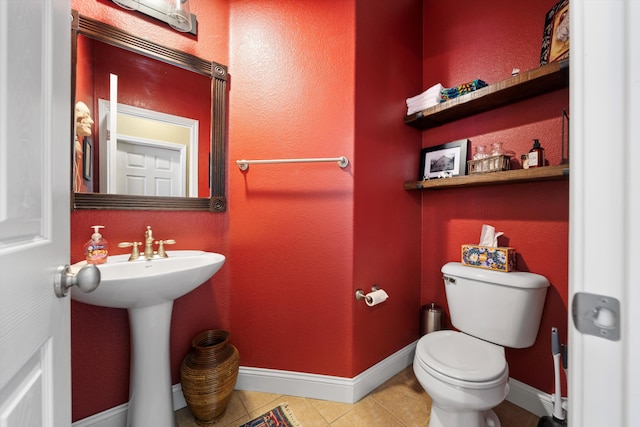 bathroom with tile patterned flooring, a sink, toilet, and baseboards