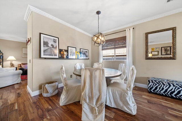 dining area with a chandelier, ornamental molding, wood finished floors, and baseboards