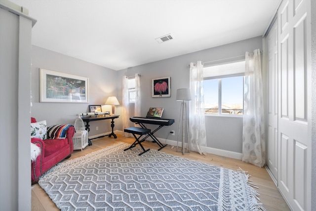 interior space with visible vents, light wood-style flooring, and baseboards