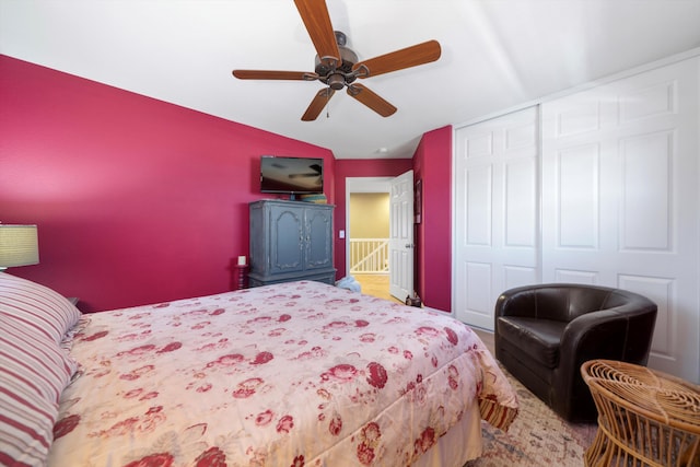 bedroom with lofted ceiling, ceiling fan, and a closet