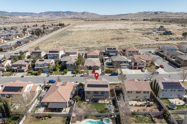 drone / aerial view featuring a residential view and a mountain view