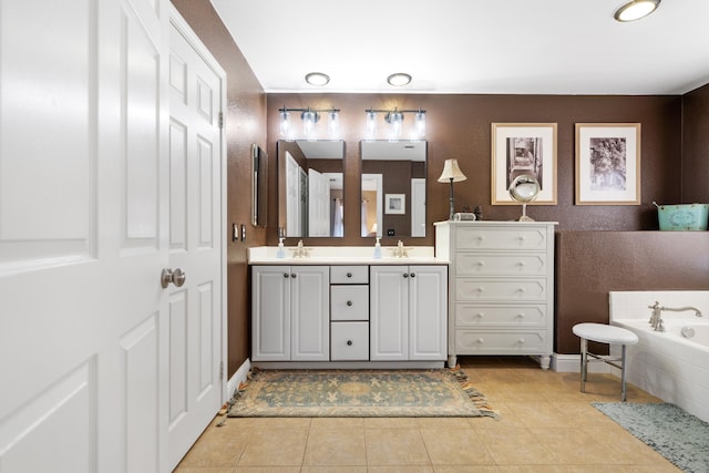 bathroom with a garden tub, double vanity, tile patterned flooring, and baseboards