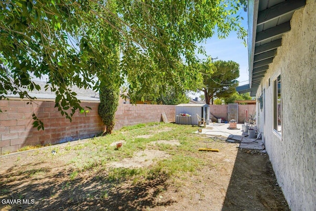 1109 W W Ave Unit J8, Lancaster, CA 93534 - fenced backyard featuring a storage unit and a patio