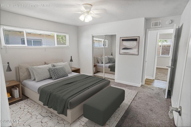 1109 W W Ave Unit J8, Lancaster, CA 93534 - bedroom with multiple windows, a closet, light carpet, and ceiling fan