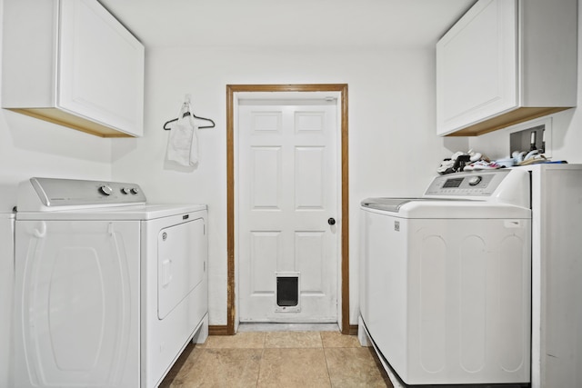 clothes washing area featuring cabinets, independent washer and dryer, and light tile patterned floors