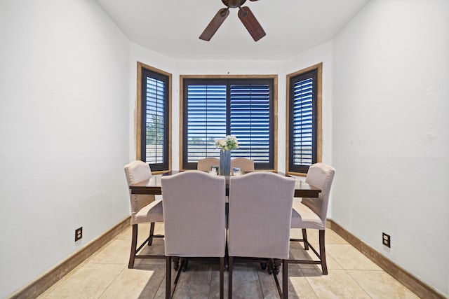 dining space with ceiling fan and light tile patterned floors