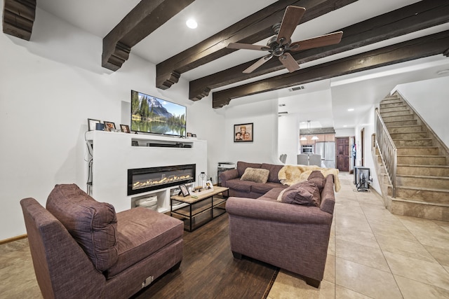 tiled living room with ceiling fan and beamed ceiling